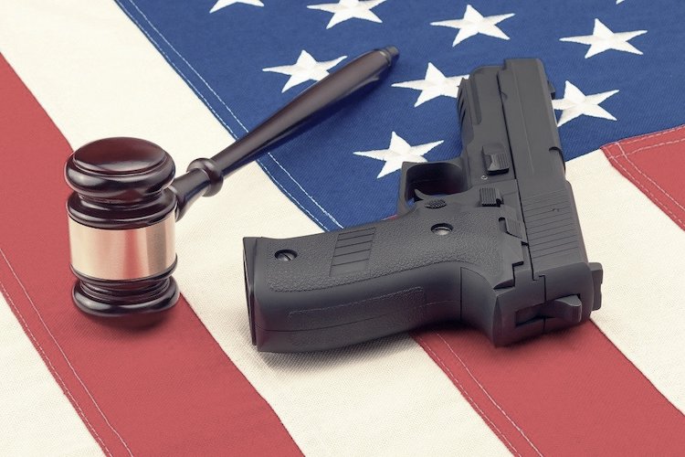Gun and judge's hammer on American flag